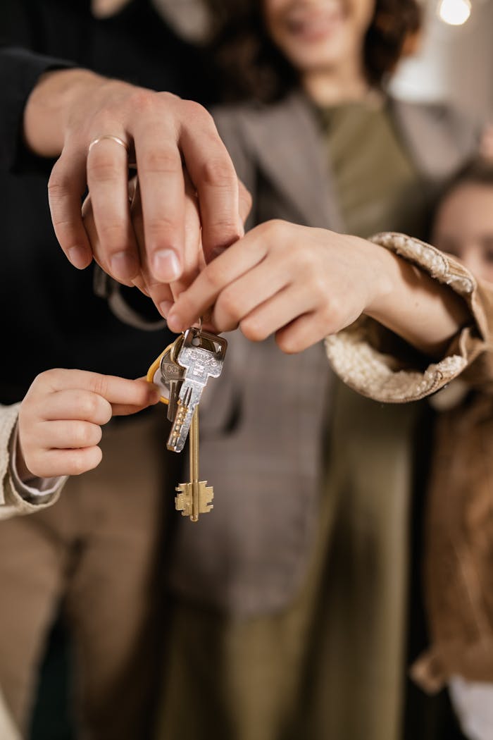 Close-up of a family holding house keys, symbolizing home ownership.